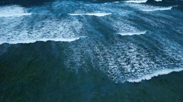 Aerial view of stunning texture and power of dark ocean waves with white foam video