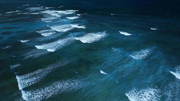 Intense dark waves with white foam, aerial view of breaking surf, barrier reef video