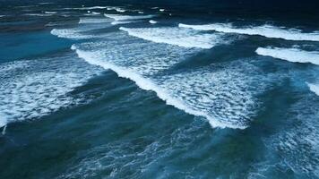 Aerial view of stunning texture and power of dark ocean waves with white foam video