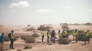 Film crew in the desert. trucks rush along the steppe road. High quality 4k footage video