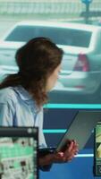 Vertical Supervisor gathering intelligence from satellite based surveillance footage, diverse team of operators analyzing traffic through security cameras. Control center license plate reading. Camera A. video