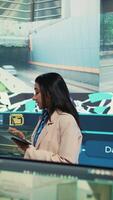 Vertical Indian manager gather intelligence via gps coordinates to ensure cargo delivery, supervising her diverse team to update the customers on their order tracking services. Satellite system. Camera B. video