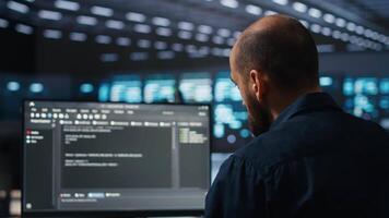 IT supervisor overseeing server room, running code on PC, troubleshooting rigs. Software admin upgrading hardware clusters, networking systems and storage arrays, close up shot video