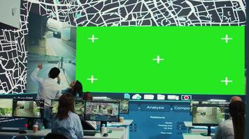 Indian supervisors gather intelligence on delivery trucks routes, look at an isolated mockup display in monitoring room. Diverse employees handling order tracking to avoid heavy traffic. Camera B. video