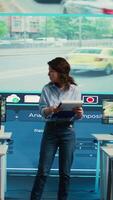 Vertical Portrait of woman supervisor overseeing the traffic surveillance monitoring activity in a observation room, CCTV satellite system. Diverse team of people handling license plate reading. Camera B. video