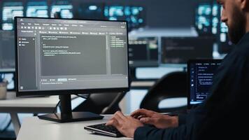 IT employee programming in server hub housing supercomputers storing datasets. Close up shot of expert typing code on computer to mend data center racks doing complex computational operations video