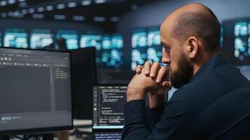 Computer scientist working in network security data center facility, ensuring optimal performance. It support employee monitoring energy consumption across operational server racks video