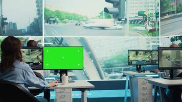 Agency operator monitoring traffic through radar surveillance with a mockup layout, using greenscreen next to CCTV footage. Employee gathering data on cars, satellite sensors. Camera B. video