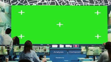 Indian supervisors gather intelligence on delivery trucks routes, look at an isolated mockup display in monitoring room. Diverse employees handling order tracking to avoid heavy traffic. Camera A. video