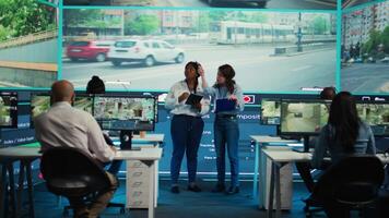 Team of control center employees gather intelligence about cars in traffic, monitoring the activity in the city via surveillance footage on CCTV security cameras. Infrastructure tracking. Camera B. video