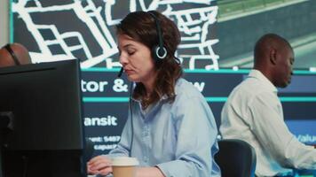 Woman call center operator transmitting directions through traffic after monitoring surveillance radar system at stop lights. Employee working on order tracking and express delivery. Camera A. video