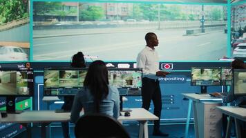 Team leader supervising his employees monitoring the traffic, diverse people employing surveillance camera in the city. Control center tracking radar footage via CCTV security system. Camera B. video