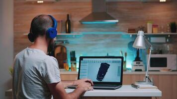 Remote man architect working from home at laptop on modern cad program overtime wearing headset. Industrial employee studying prototype idea on computer showing cad software on device display video