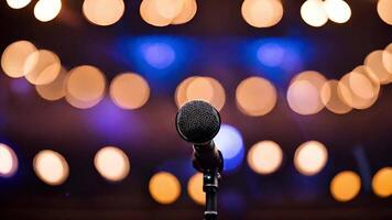 Dynamic microphone on stage with bokeh lighting, ideal for live music events, stand up comedy nights, and World Music Day celebrations video