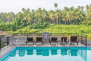 View of swimming pool in hotel nearly riverside in Pinnawala village, Sri Lanka. Pinnawala is the best place to see largest herd of captive elephants in the world. photo