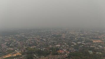 Aerial view of an environment in Chiang Rai city covered with bad air pollution such as PM 2.5. PM2.5, A harmful thing is toxic air pollution. photo