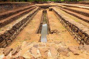 A pool in the garden complex of Sigiriya palace Sri Lanka. Sigiriya has water gardens a complex hydraulic system, which consists of canals, lakes, dams, fountains, as well as underground water pumps. photo