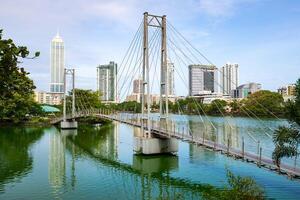 View of Colombo cityscape and skyscrapers with a bridge on Beira Lake a lake in the center of the city. Colombo is the commercial capital and largest city of Sri Lanka. photo