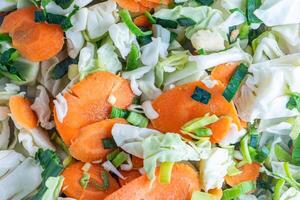 A vibrant assortment of julienned vegetables featuring finely sliced cabbage, leeks, and carrots. This colorful mix is perfect for adding texture and flavor to dishes. photo