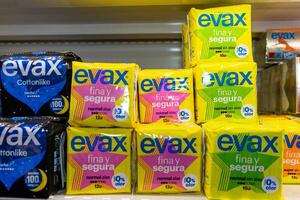 Evora, Alentejo, Portugal, March 1, 2024. A display of Evax sanitary pads on a store shelf. The products are neatly arranged in rows, with various types and sizes clearly visible in the packaging. photo