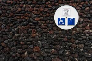 Signage indicating a shower area with facilities for both regular and disabled individuals, situated in a beachfront location. photo