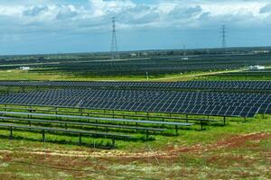 Solar panels gleam under the sun on a rural estate, harnessing clean energy amidst serene countryside. photo