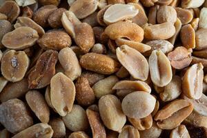 Close-up of salted shelled peanuts, ideal for food and snack enthusiasts. photo