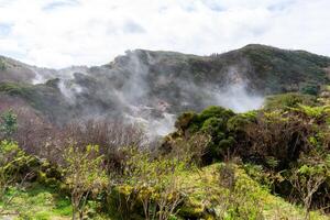 Surreal landscape of sulfur fumaroles at Terceira Island, Azores. Captivating natural wonders amid volcanic terrain. photo