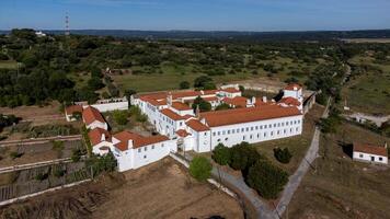 Evora, Alentejo, Portugal. May 7, 2024. Aerial view of the Monastery of Sao Bento de Castris in Evora, Portugal. The image captures the intricate architecture and the surrounding lush landscape photo