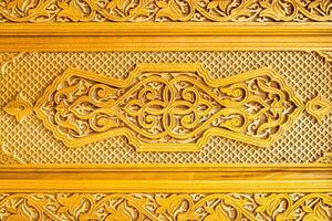 Fragment of an ancient carved wooden door. Ornate. photo