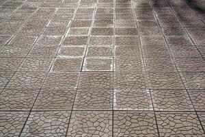 The texture of a tiled pavement with perspective. photo