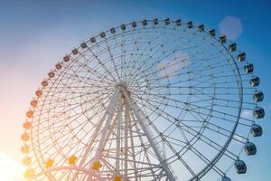 Ferris wheel at sunset or sunrise in an amusement park. photo