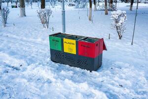 Iron multi-colored containers for separate waste collection. photo