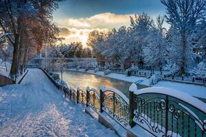 Sunset or dawn on a canal with non-freezing water on a cold winter day. photo