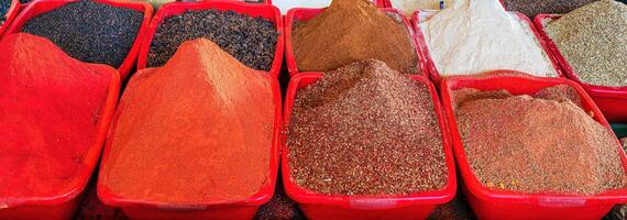 Multi-colored oriental spices on the counter of the bazaar. photo