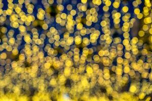 Blured festive garlands with glowing light bulbs against the background of the night sky. photo