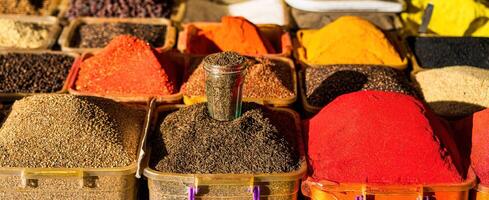 Multi-colored oriental spices on the counter of the bazaar. photo