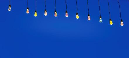 Holiday garlands with lamps against the black night sky. photo