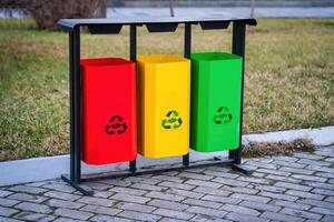 Iron multi-colored containers for separate waste collection. photo