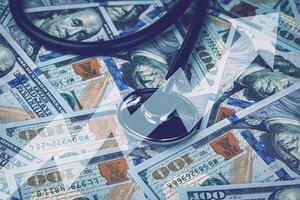 Stethoscope on the background of one hundred dollar bills. photo