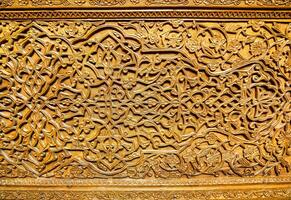 Fragment of an ancient carved wooden door. Ornate. photo