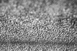 Monochrome texture of shiny grained metal. Abstract background. photo