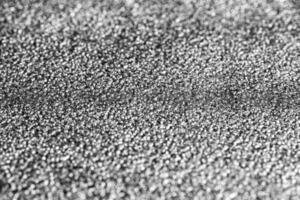 Monochrome texture of shiny grained metal. Abstract background. photo