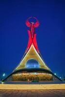 UZBEKISTAN, TASHKENT JANUARY 4, 2023 Illuminated monument of independence in the form of a stele with a Humo bird in the New Uzbekistan park at night. photo