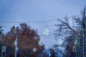 New Year or Christmas festive snowflake and garlands hanging in rows. photo