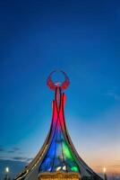 UZBEKISTAN, TASHKENT JANUARY 4, 2023 Illuminated monument of independence in the form of a stele with a Humo bird in the New Uzbekistan park at night. photo