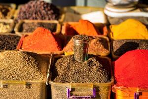 Multi-colored oriental spices on the counter of the bazaar. photo