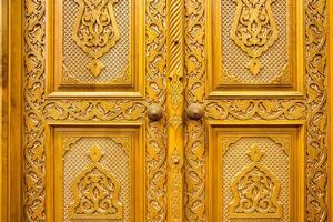 Carved wooden doors with patterns and mosaics. Abstract background. photo