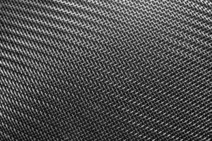 Monochrome texture of a shiny metal colander or grate. Abstract background. photo