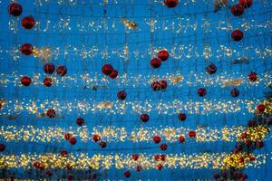 New Year or Christmas festive balls and garlands hanging in rows against the night sky. photo